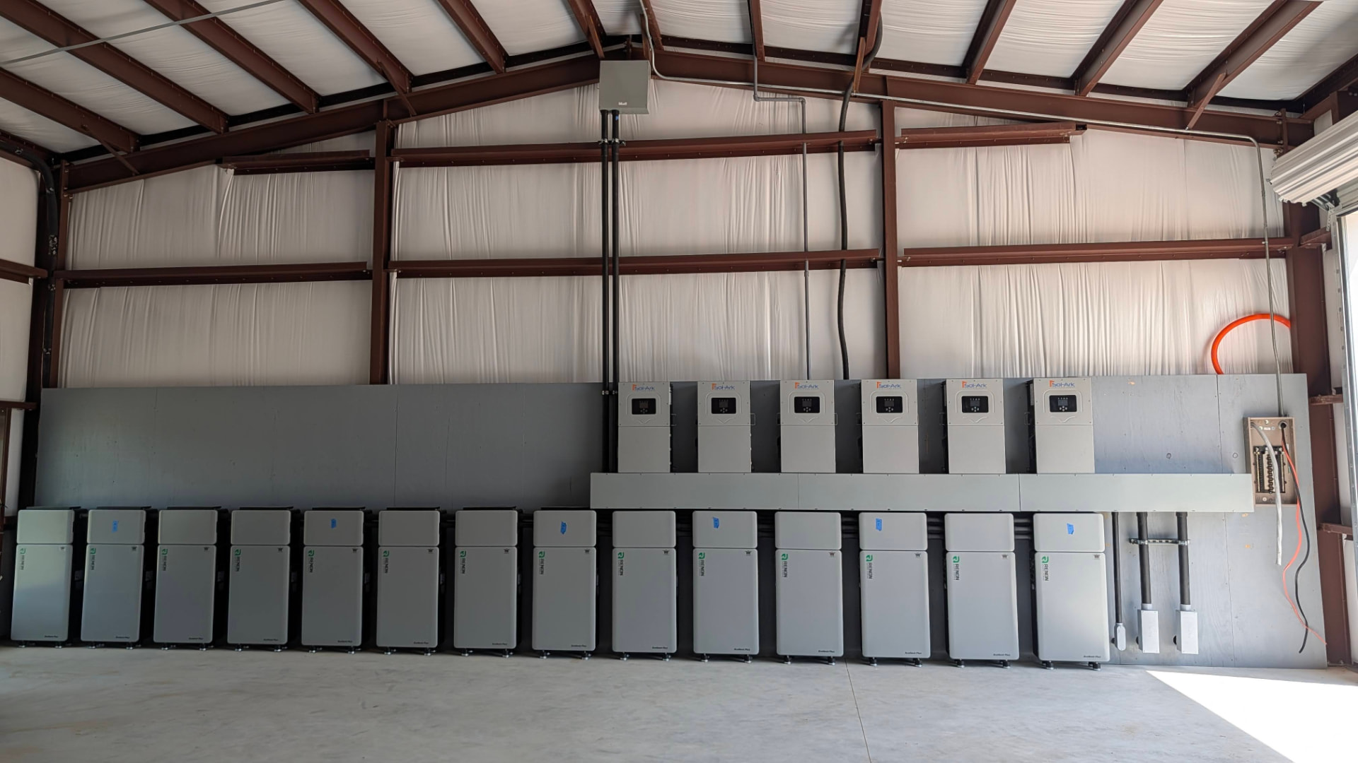 Equipment room — 6 × Sol-Ark 15K inverters paired with the Renon Power Xcellent Plus battery wall.