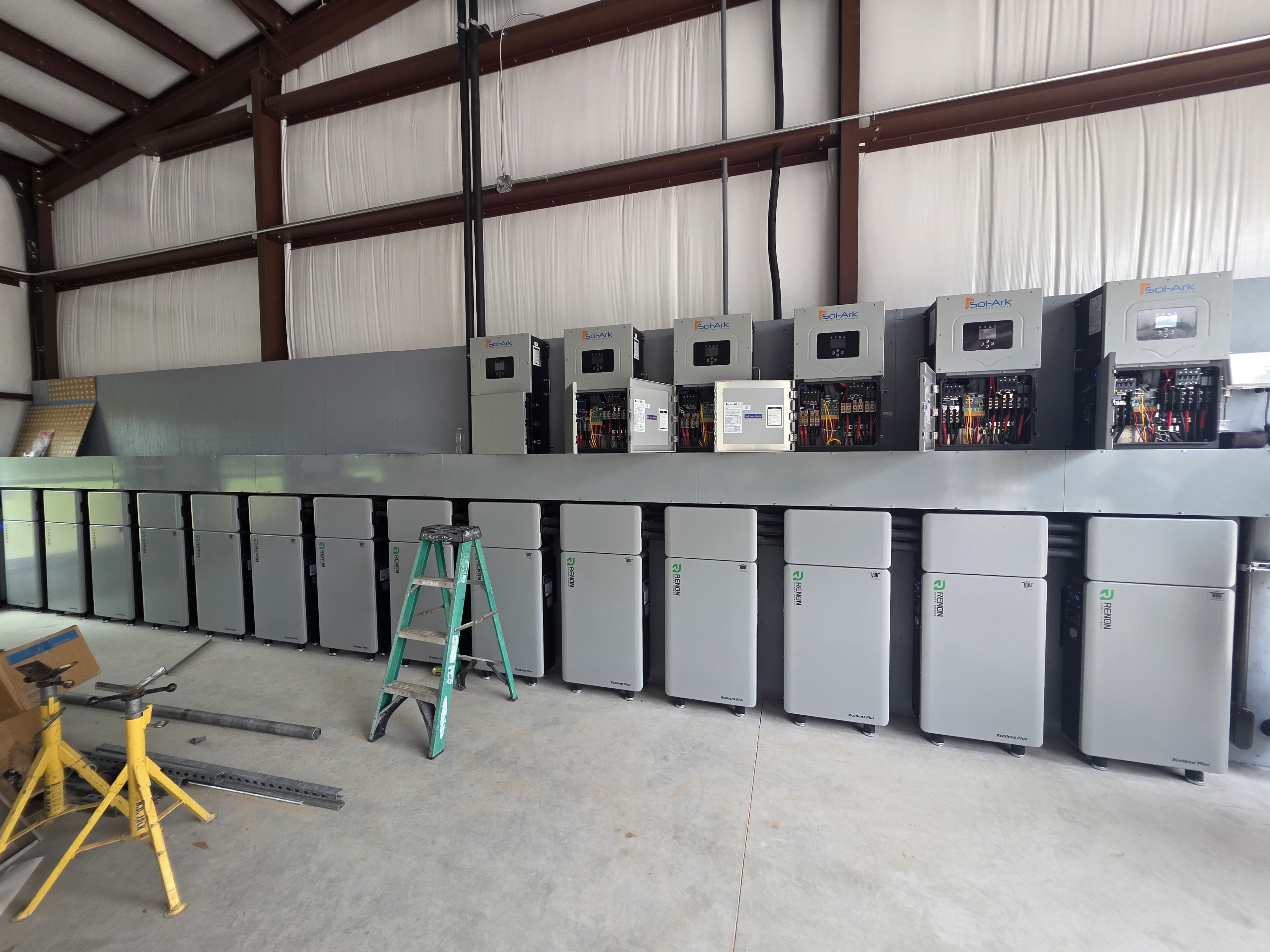 Equipment room — 6 × Sol-Ark 15K inverters paired with the Renon Power Xcellent Plus battery wall.